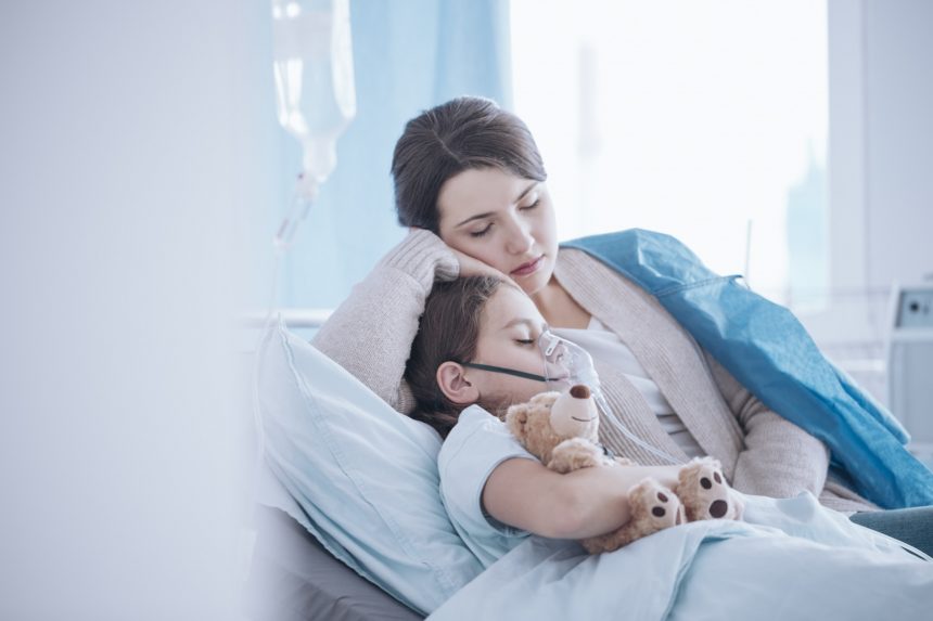 Mother taking care of sick daughter with oxygen mask and teddy bear